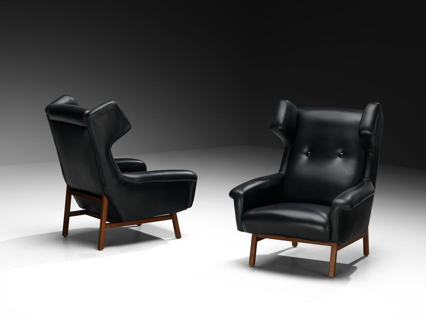 Italian Pair of Wingback Lounge Chairs in Black Leather and Mahogany